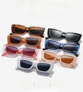Flat lay of colorful rectangular sunglasses in tortoiseshell, black, orange, and blue frames