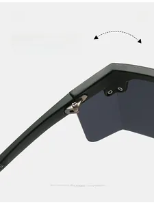 Macro view of durable metal hinge on matte dark green oversized sunglasses