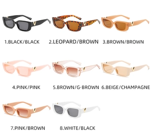 Detail view of rectangular sunglasses showing a golden V-shaped metal logo on the temple
