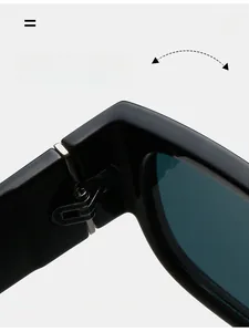 Detail view of durable metal hinges on vintage small frame black sunglasses for women