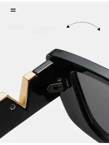 Close-up of durable gold metal hinge on premium black square frame sunglasses