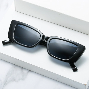 Classic vintage black square frame sunglasses with dark lenses on a geometric stand