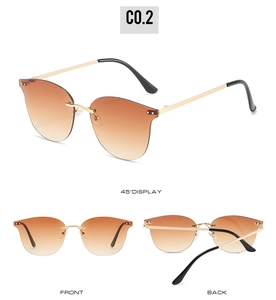 Detail view of rimless brown gradient sunglasses with golden metal hinges and temples