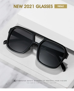 Macro view of square black oversized sunglasses with double bridge and dark grey lenses