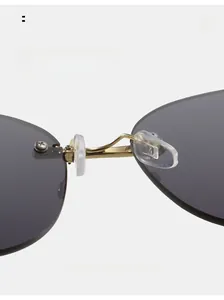 Macro shot of comfortable silicone nose pads and gold metal bridge on rimless sunglasses