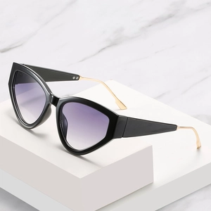 Fashionable black cat eye sunglasses with purple gradient lenses and gold metal temples