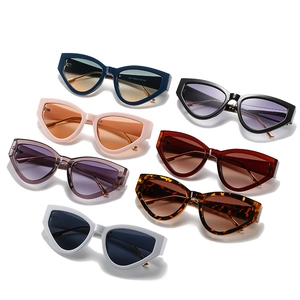 Collection of vintage oversized cat-eye sunglasses in multiple colors on white background