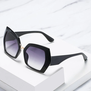 Modern hexagonal cat-eye sunglasses with black frame and purple gradient lenses