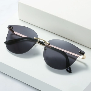Fashionable rimless cat eye sunglasses with grey gradient lenses and gold metal frames