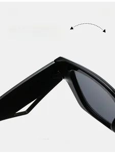Detail view of durable texture hinges on wide-frame black sunglasses for women