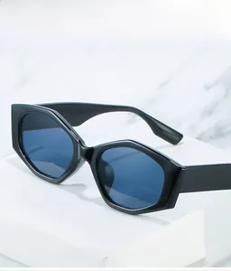 Detail shot of black hexagonal sunglasses with thick frames on marble background