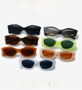 Flat lay of geometric cat-eye sunglasses in seven assorted colors on a white backdrop