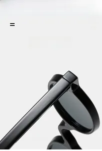 Detail of vintage round sunglasses showing the thick black frame and temple texture