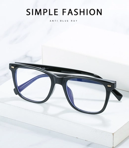 Detail of black square TR90 glasses frames with gold rivets and anti-blue light lenses