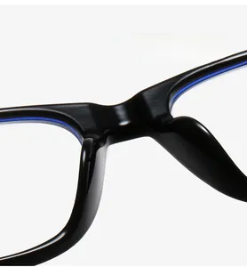 Detail of ergonomic integrated nose pads on black TR90 frames with blue accents