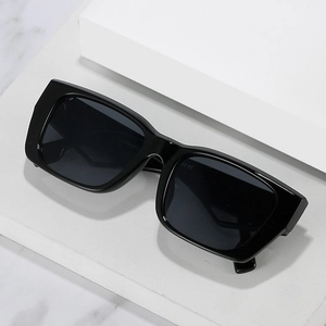 Classic black oversized rectangle sunglasses with wide temples on a minimalist white stand