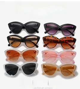 Flat lay of retro cat-eye sunglasses with metal V-shaped accents in multiple colors