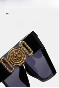 Detailed close-up of gold rose metal carving on black square oversized sunglasses