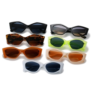 Set of irregular geometric cat eye sunglasses in seven vibrant colors on white background