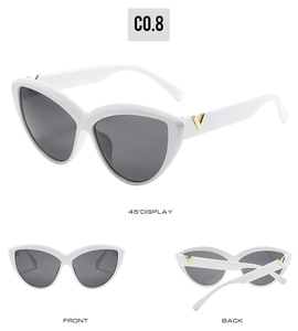 Detail of white oversized cat-eye sunglasses featuring golden V metal accents on temples