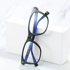 Square black TR90 anti-blue light glasses frame with rivet decor on marble background