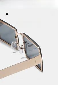 Detail of square gold sunglasses featuring comfortable silicone nose pads and metal bridge