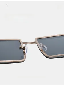 Close-up of adjustable silicone nose pads on gold metal frame square sunglasses