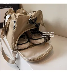 Detail view of the dedicated side shoe compartment in a khaki canvas travel sports bag