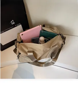 Spacious interior of khaki nylon travel bag showing storage for tablet and umbrella