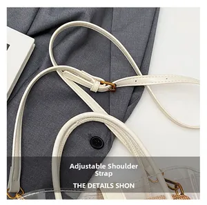 Detail of white adjustable leather shoulder strap with golden metal buckle on tote bag