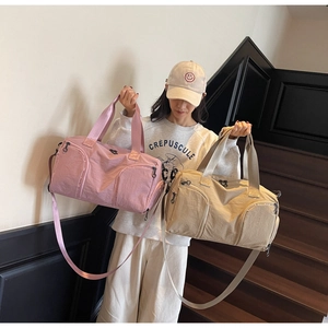 Large waterproof nylon gym bags in pink and beige colors with wide crossbody straps