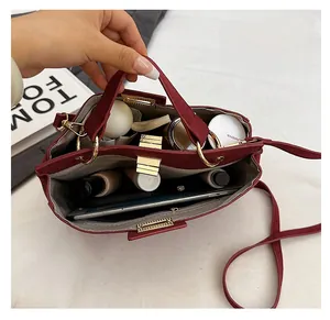 Interior view of red matte tote bag showing large capacity with tablet and cosmetics