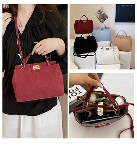 Detail view of suede textured tote bag with golden twist lock and internal compartments