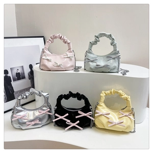 Collection of ruched handle handbags with bow accents in five colors and metallic chain straps