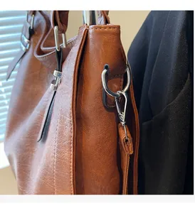 Close-up of caramel brown pebble leather tote bag with silver hardware and fine stitching