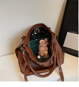 Interior view of brown faux leather tote showing large capacity with daily essentials