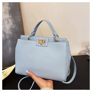 Light blue lychee pattern leather handbag with gold twist lock and shoulder strap