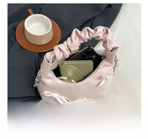 Pink pleated handbag detail showing interior capacity for phone, wallet and cosmetics