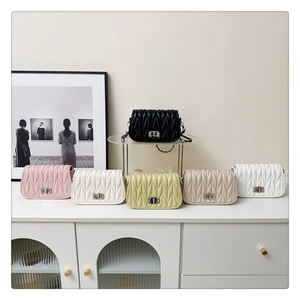 Detailed display of five colors of quilted shoulder bags with chain straps and metal locks