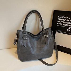 Minimalist large dark gray leather tote bag with top handles and adjustable strap