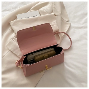 Detailed interior of pink square crossbody bag with phone and wallet storage