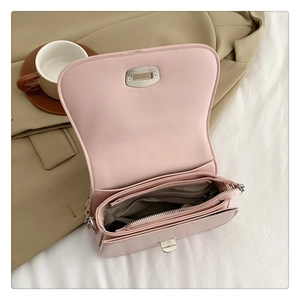 Detail of light pink soft leather bag with three internal compartments and chain strap