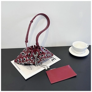 Burgundy bucket bag with silver grommets, pearl drawstring, and matching inner pouch