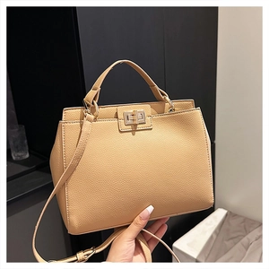 Vintage apricot matte crossbody handbag with pebble texture and golden twist lock