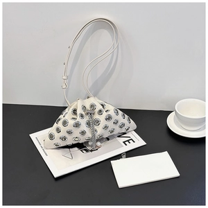 Detail of white studded bucket bag with silver eyelets and pearl drawstring chain