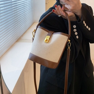 Retro canvas and brown leather bucket bag with gold lock and adjustable shoulder strap