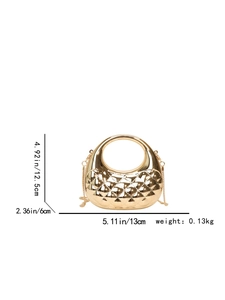 Detailed view of golden metallic evening bag with geometric quilted texture and round handle