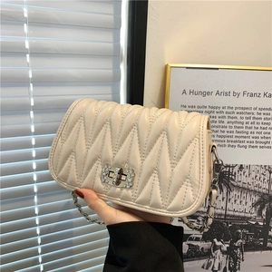 Off-white V-quilted leather crossbody bag with crystal-embellished silver turn-lock and chain
