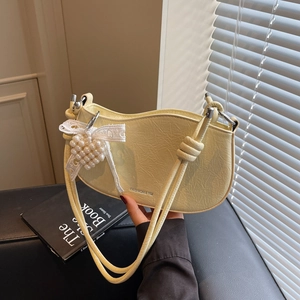 Minimalist cream yellow baguette bag with lace bow and pearl heart charm detailing