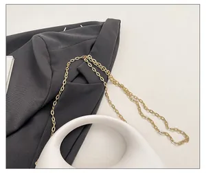 Exquisite gold metal chain strap detail on luxury acrylic evening clutch bag